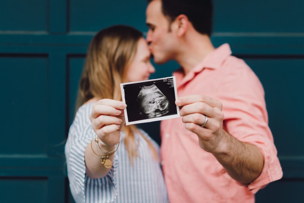 Some friends of mine holding an ultrasound picture of their sweet baby